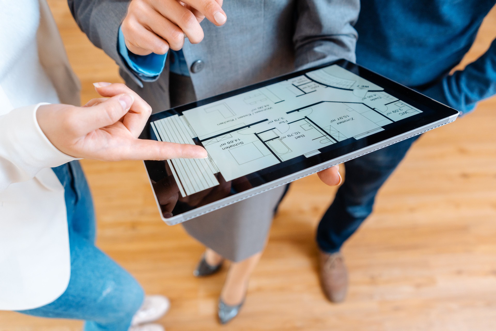 Real Estate Agent explaining floor plan to couple buying a house